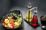 Set de 2 distributeurs à vinaigre et à huile Gefu X-Plosion en verre 250ml + support acacia